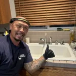 plumber with repaired sink