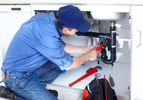plumber repairing fixture